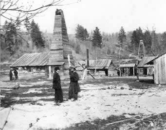 Edwin L. Drake (right) in front of the Drake Well engine house in 1861.