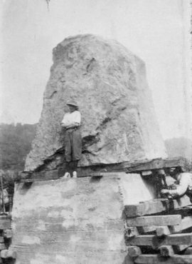 Ida Horner standing in front of the boulder she found for the DAR Monument, 1913